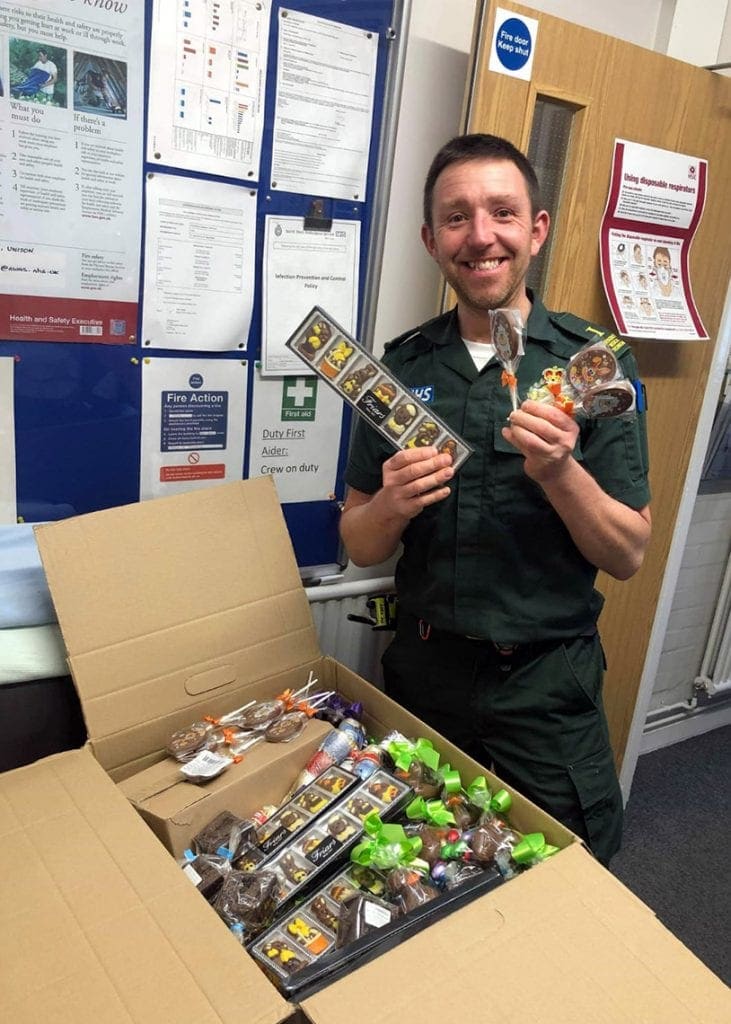 Ambulance technician Dan Jordan receiving the chocolate treats from Ye Olde Friars at the Keswick  station.