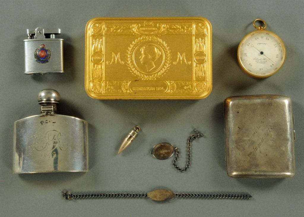 Personal memorabilia including the bullet which injured the colonel, dog tags, lighter and tobacco tin