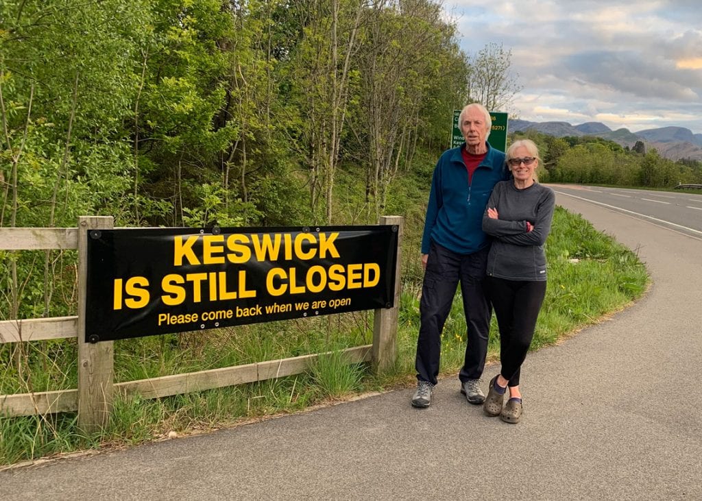 Keswick's mayor Cllr David Burn and his wife Elaine at one of the signs which say 'Keswick is still closed - Please come back when we are open’