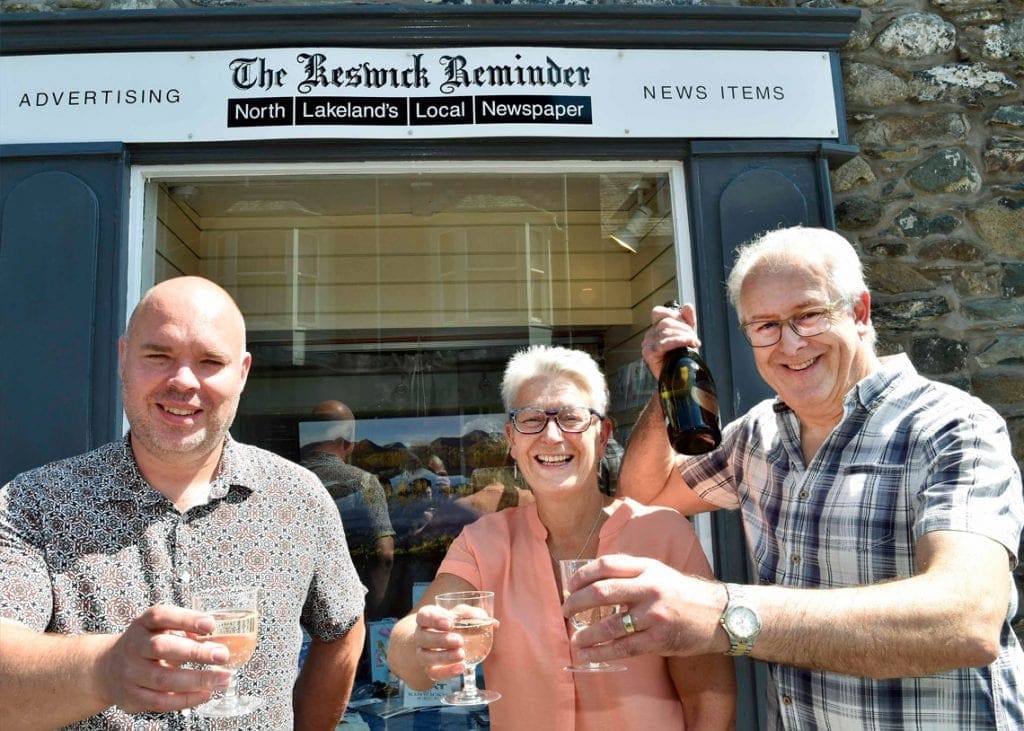 HOLD THE FRONT PAGE Andy Barr (left) toasts the future of the Keswick Reminder with former owners Jane Grave and David Branthwaite.