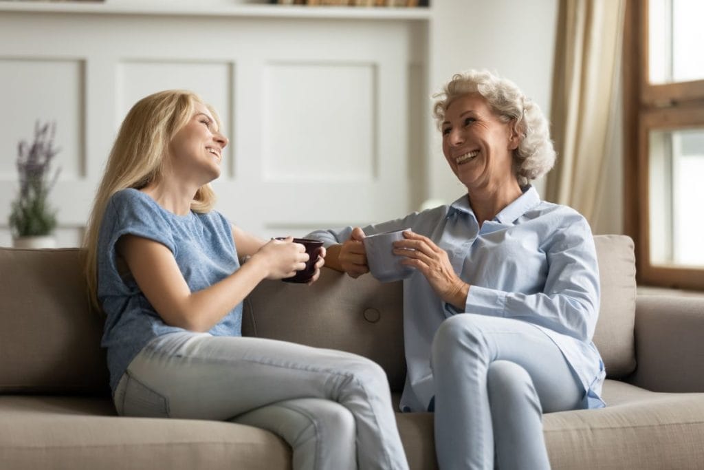 older lady younger woman drinking coffee