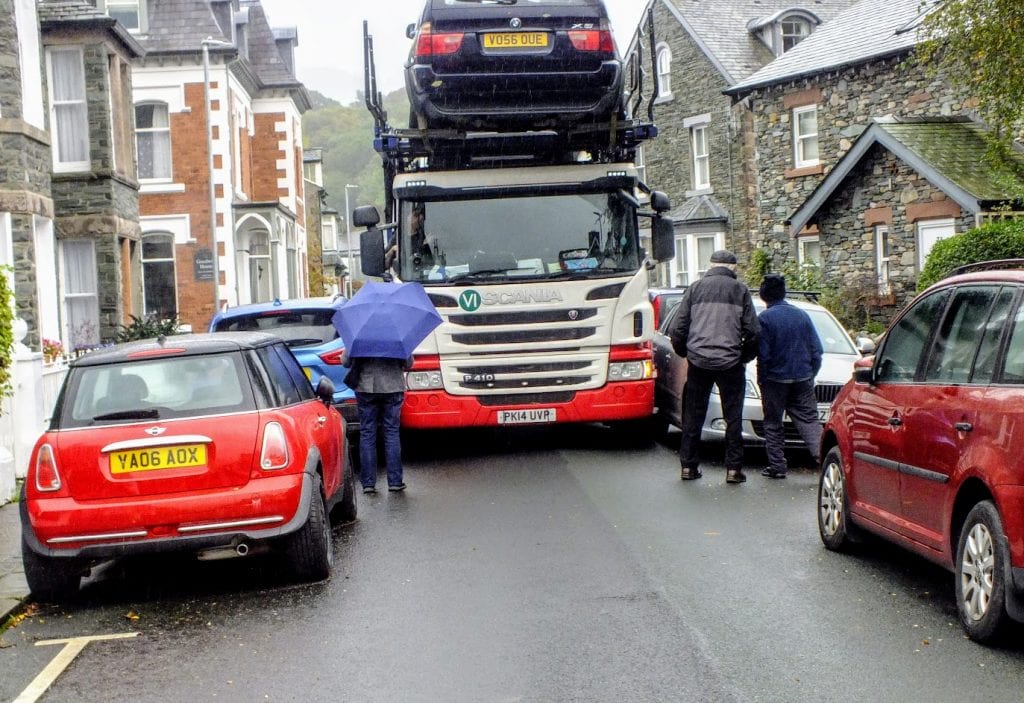 Traffic was brought to a standstill in a side street of Keswick this afternoon as a large vehicle transporter got stuck on Southey Street – centimetres away from parked cars.