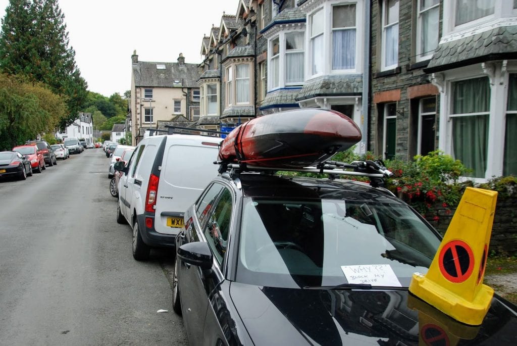 A car in Keswick with a traffic cone on the bonnet and a note from a home owner asking: "Why block my drive"