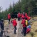 Mountain rescuers gather around the stricken mountain biker at Whinlatter Forest