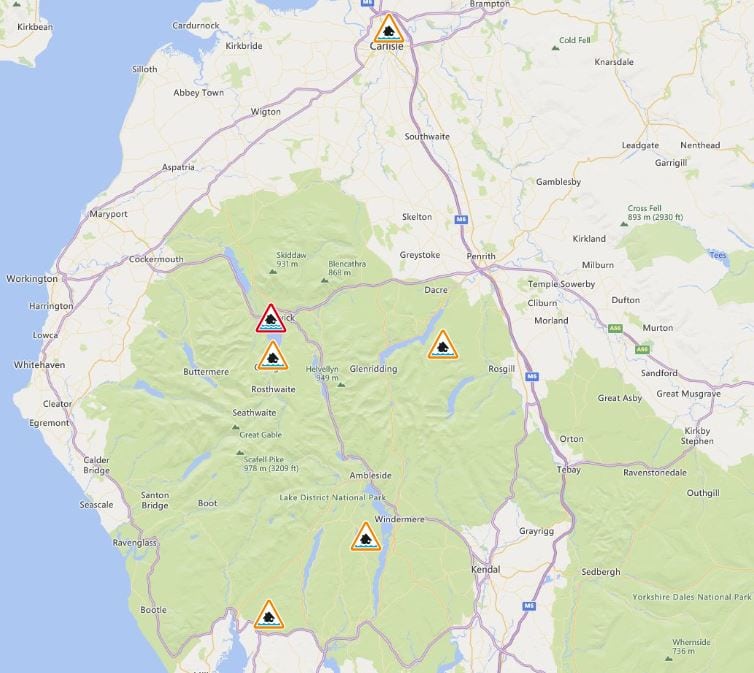 A map shows the areas where flood warnings or alerts are in force in Cumbria. A yellow triangle with a house inside and water below it indicates a flood alert. A red version of the triangle is used for flood warnings