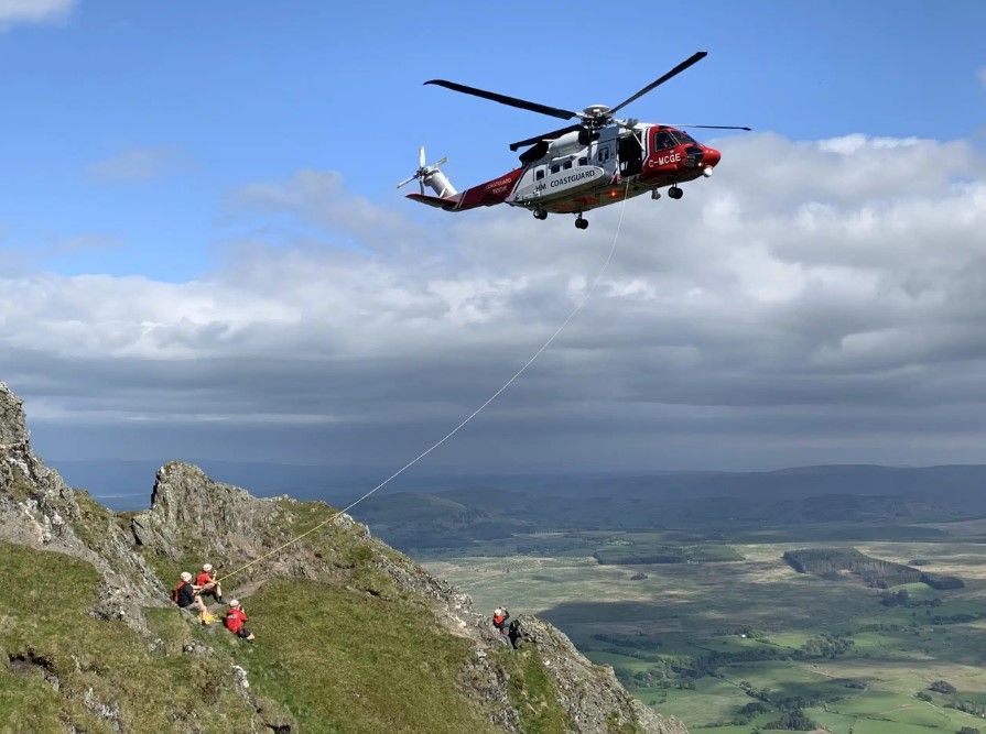 Helicopter hovering close to mountainside