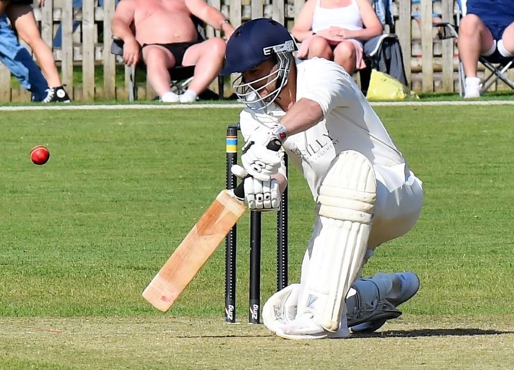 Cricket batsman playing a defensive shot